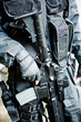 The armed soldier in a camouflage costs in alertness The armed soldier in a camouflage costs in alertness