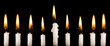 Beautiful lit hanukkah candles on black.