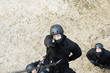 SWAT Team Officer Rappelling and Aiming Gun