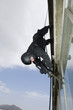 SWAT Team Officer Rappelling from Building