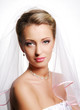 Portrait of cute young bride wearing  white vial.