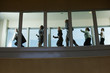 Businesspeople Running down Hallway