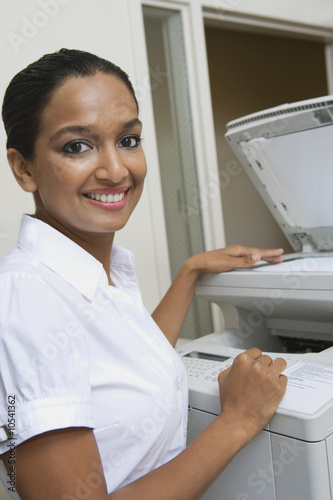 Photo: Businesswoman Using Photocopier Businesswoman Using Photocopier