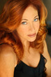 Closeup portrait of a sexy red-headed woman in black