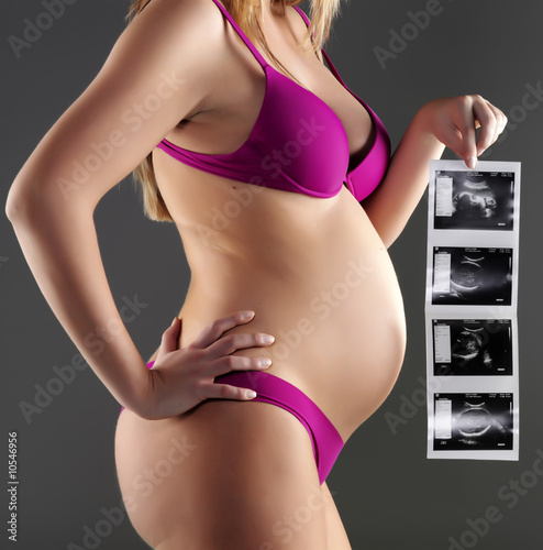 pregnant woman carrying her child's ultrasound picture
