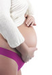 Image of pregnant woman touching her belly with hands