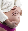 Image of pregnant woman touching her belly with hands