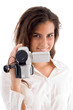 smiling woman holding video camera on an isolated background