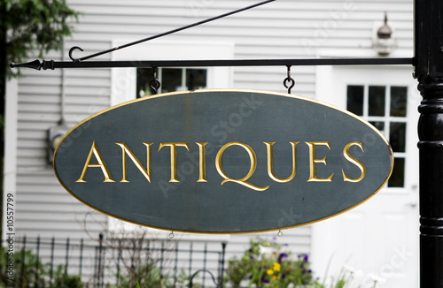 Photo: Sign with text 'antiques' in gold on green Sign with text 'antiques' in gold on green
