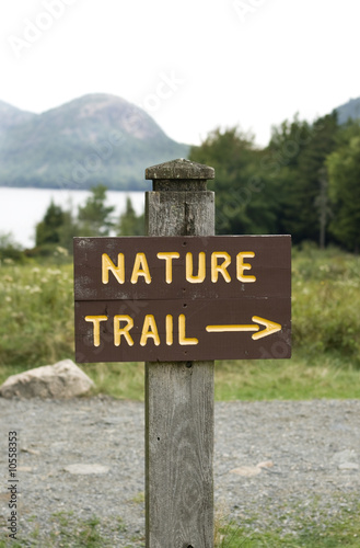 Photo: Wooden post with sign and text: 'nature trail' and arrow Wooden post with sign and text: 'nature trail' and arrow