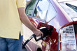 male topping up car tank with unleaded 95 gasoline