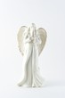 White porcelain angel statuette on white background.