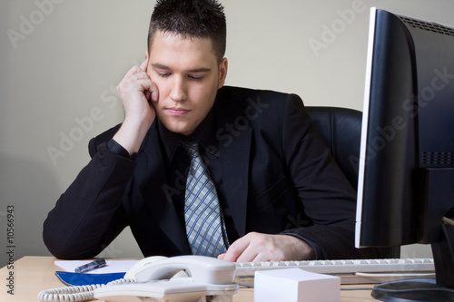 Photo: man working at his office man working at his office