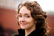 Classical portrait of attractive smiling woman outdoors