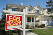 Sold Home For Sale Sign and House Sold Home For Sale Sign and House