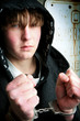 teenager in handcuffs - youth crime concept