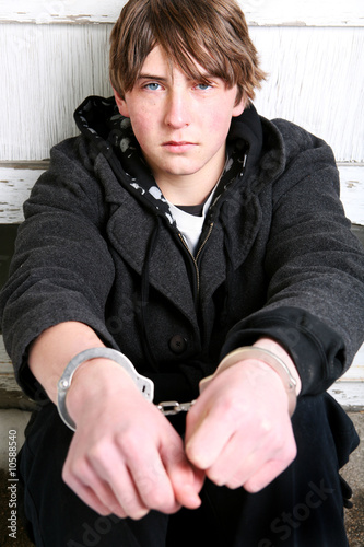 Photo: teenager in handcuffs - criminal portrait teenager in handcuffs - criminal portrait