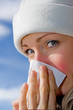 female blowing nose