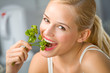 Young happy smiling woman eating at kitchen Young happy smiling woman eating at kitchen