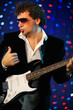 Male guitar player on stage