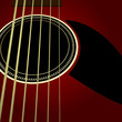 Dark acoustic guitar close up