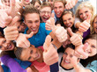 Group of successful students giving the thumbs up