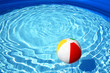 Beach ball floating on pool
