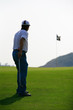 golfer walking towards the hole