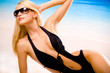 Young beautiful sexy woman in sunglasses and bikini