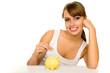 Foto: Woman putting coin in piggy bank Woman putting coin in piggy bank