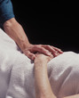 hand of a healer touches the hand of the elderly infirmed hand of a healer touches the hand of the elderly infirmed