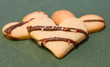 Three heartshaped cookies on green background Three heartshaped cookies on green background