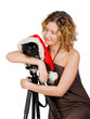 Girl and digital photo camera in a santa clause cap