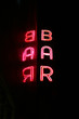 Neon bar sign with reflection