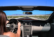 Woman driving convertible car