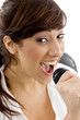 front view of smiling female singing on mic