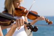 two young woman play violin two young woman play violin