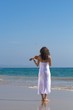 young woman play violin on beach