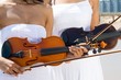 two young women holding violins on beach two young women holding violins on beach