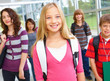 Photo: Closeup of a young girl with friends in background Closeup of a young girl with friends in background
