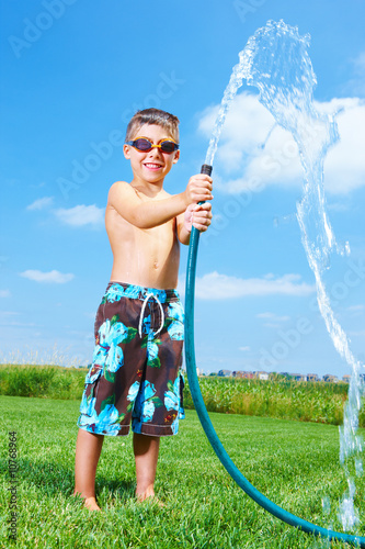 Foto: Boy standing with waterpipe Boy standing with waterpipe