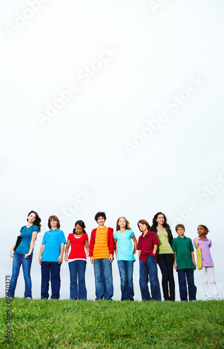 Photo: Full length of small kids standing together outdoors Full length of small kids standing together outdoors