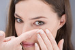 Close up of a woman putting contact lens in her eye Close up of a woman putting contact lens in her eye