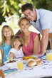 Family Enjoying A Barbeque