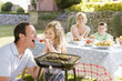 Family Enjoying A Barbeque