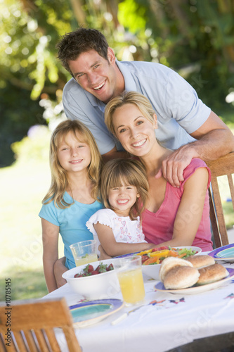 Photo: Family Enjoying A Barbeque Family Enjoying A Barbeque
