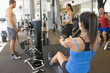 Group Of People Weight Training At Gym