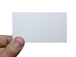 Fingers holding an empty white card isolated on white background