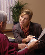 businesswoman offers a contract for signing to a senior man businesswoman offers a contract for signing to a senior man