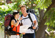 Couple with backpacks looking at map
